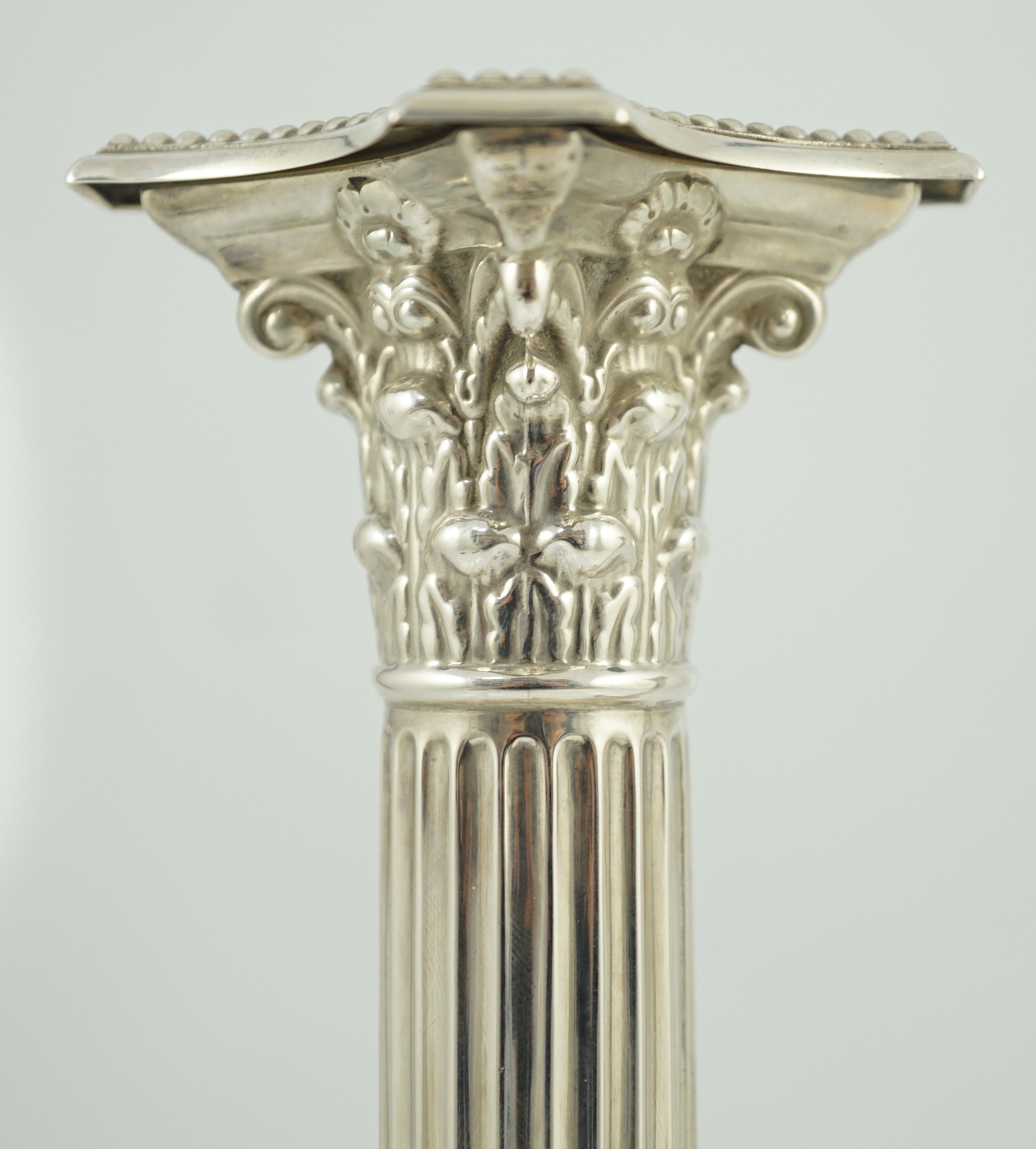 A pair of late Victorian silver Corinthian column candlesticks, by William Hutton & Sons